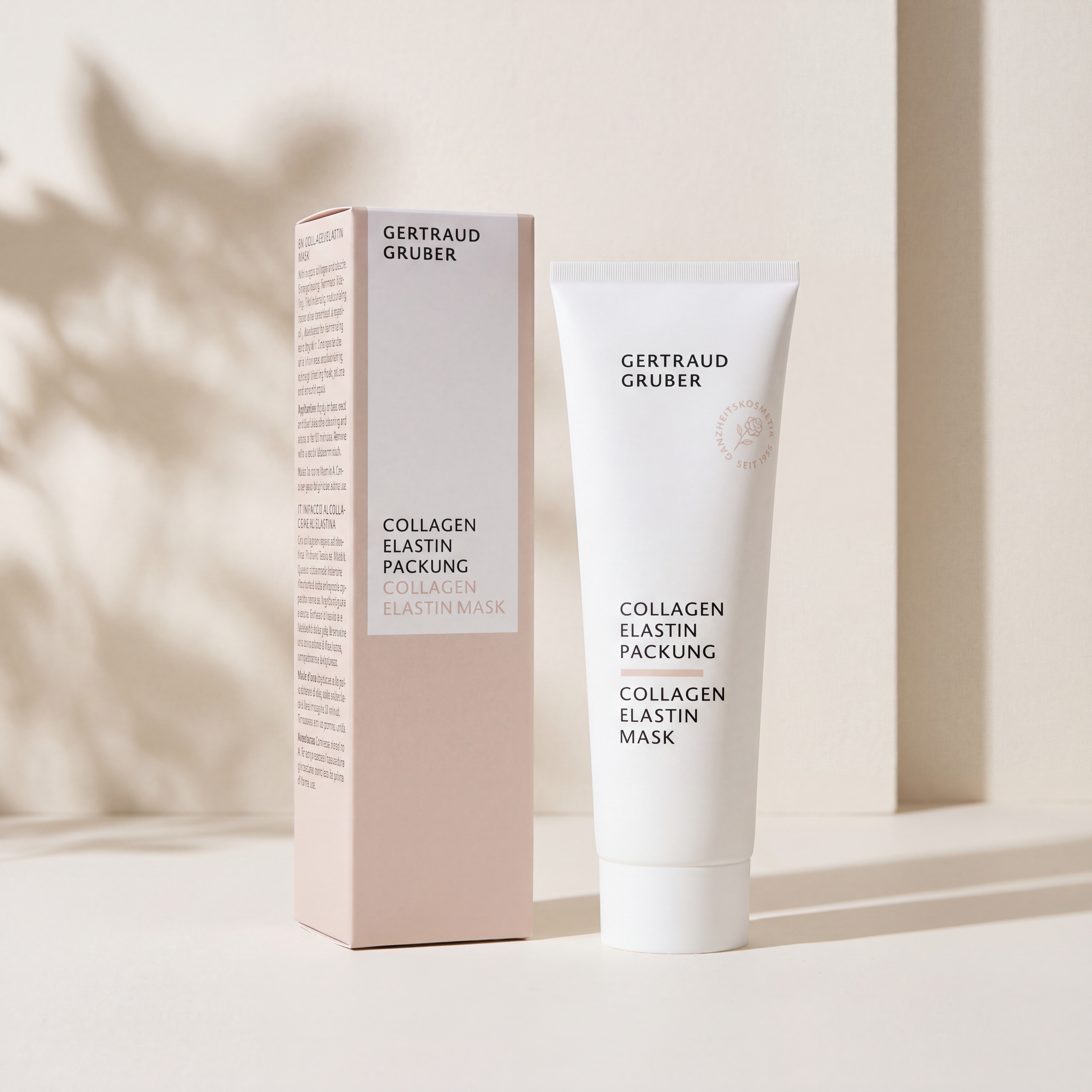 Schlanke weiße Tube Collagen Elastin Packung von Gertraud Gruber Kosmetik mit Faltschachtel vor heller Wand mit sanften Schatten