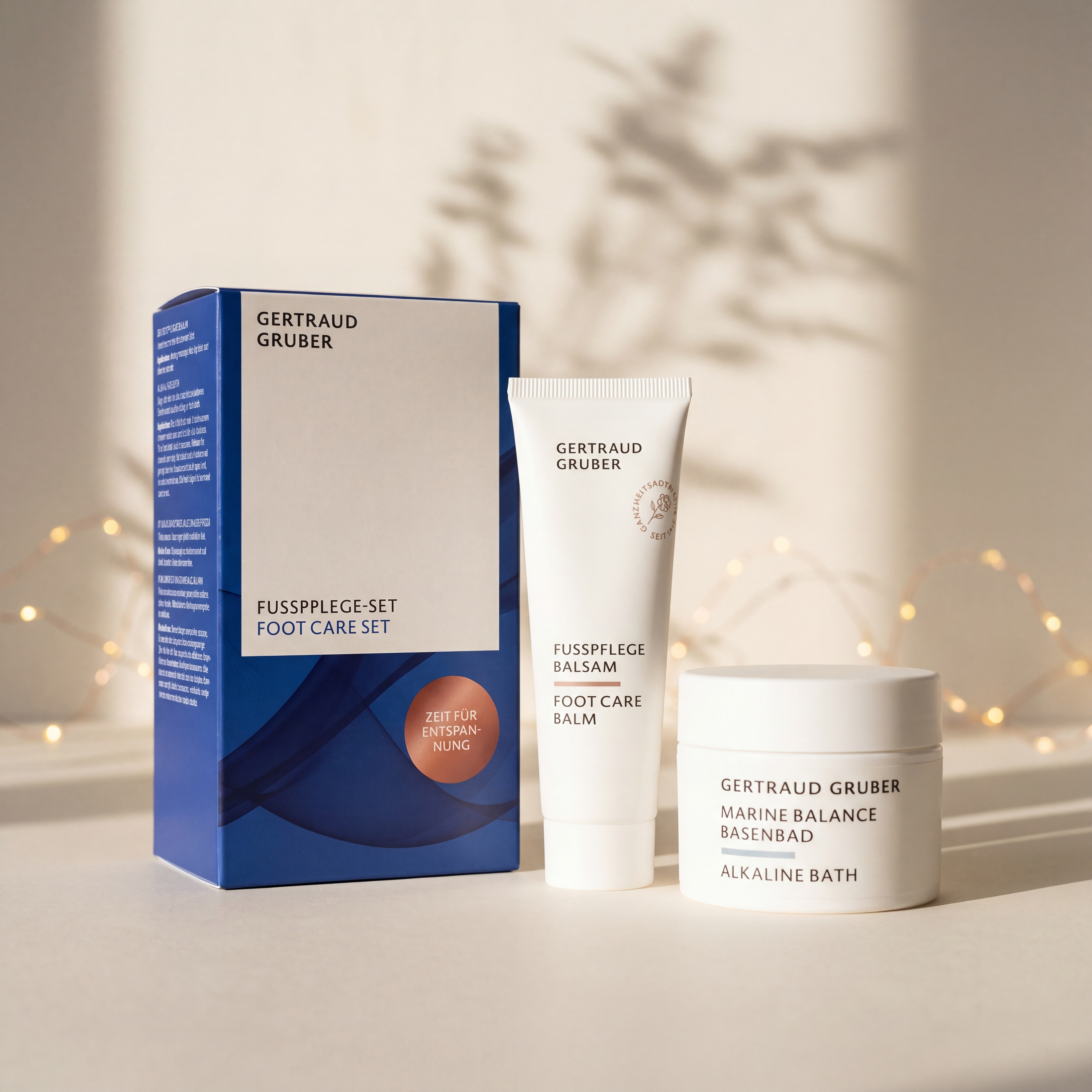 Fußpflege-Set von GERTRAUD GRUBER mit Fußpflege Balsam und Marine Balance Basenbad vor der Geschenkverpackung, stimmungsvoll inszeniert mit warmen Lichtern.